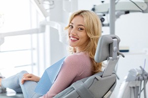 Woman smiling while sitting in treatment chair