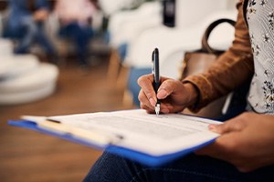 Patient filling out paperwork in lobby