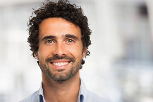 Close-up of man with facial hair smiling