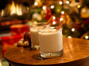 Two cups of eggnog on a wooden table
