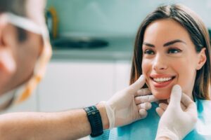 Young woman smiling at dentist.